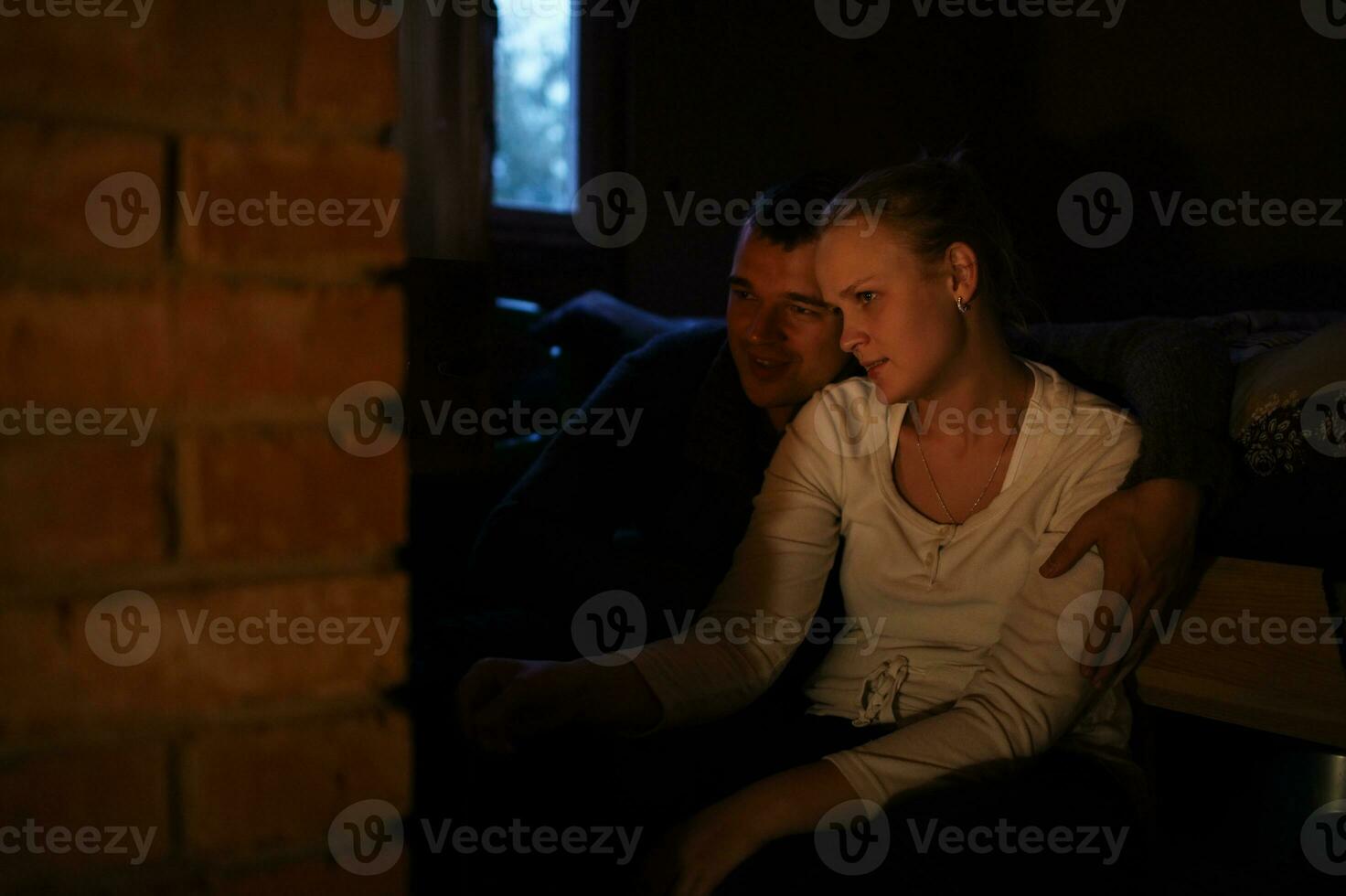 Couple warming near stove photo