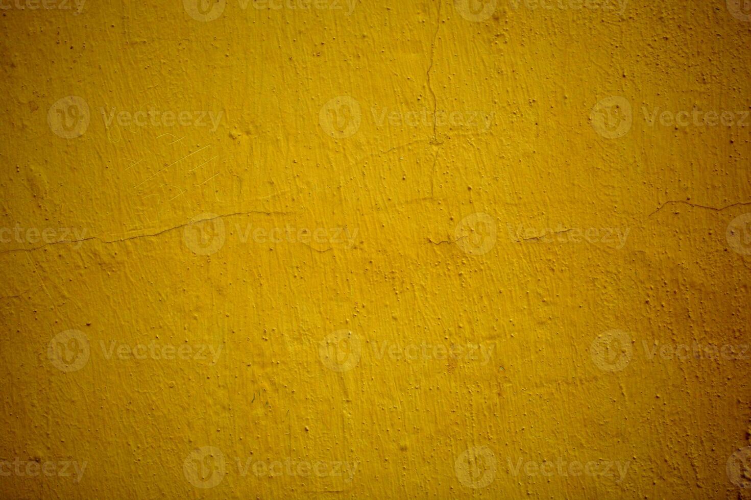 Old grungy ochre colored wall background texture photo