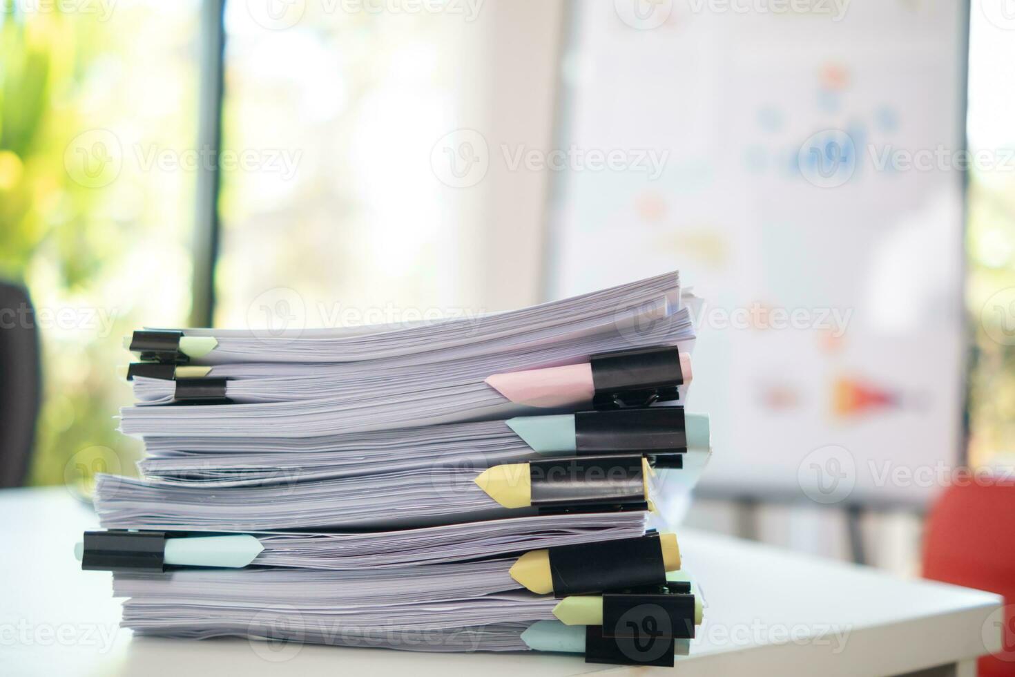 A huge stacked documents is an annual earnings summary document prepared for business people to use in attending meetings and this stacked paper is also an important document. photo