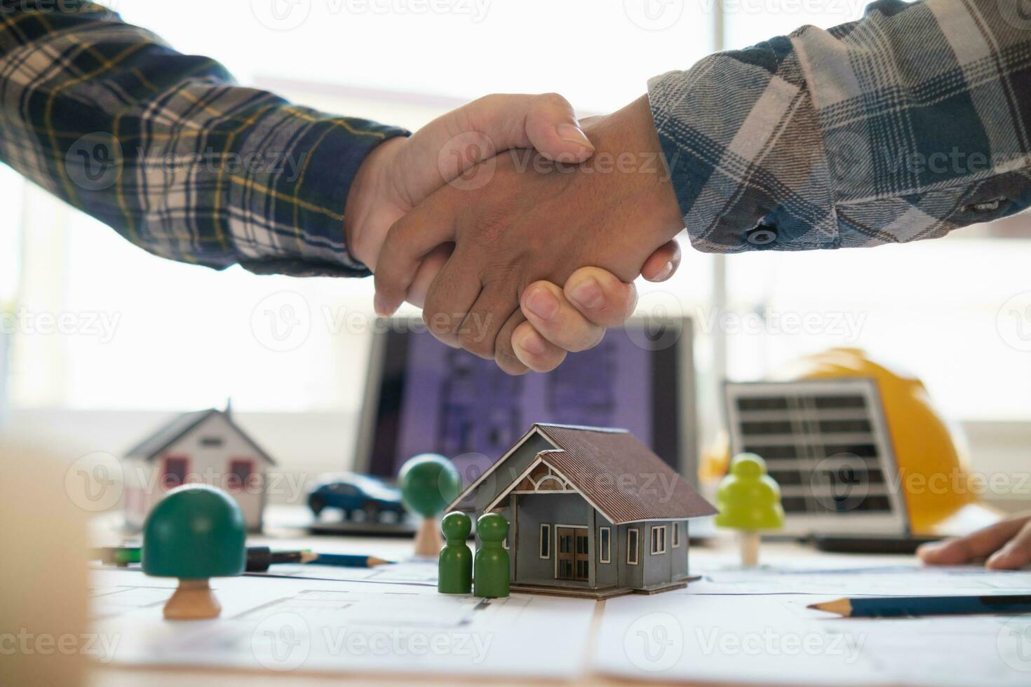 Architects and engineers join hands to congratulate when discussing and successful cooperation in planning construction project. Team of engineers and architects join hands in office after successful photo