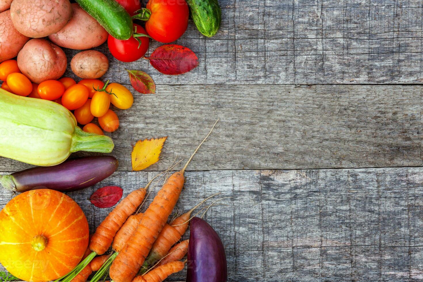 Assortment different fresh organic vegetables on country style wooden background. Healthy food vegan vegetarian dieting concept. Local garden produce clean food. Frame top view flat lay copy space. photo