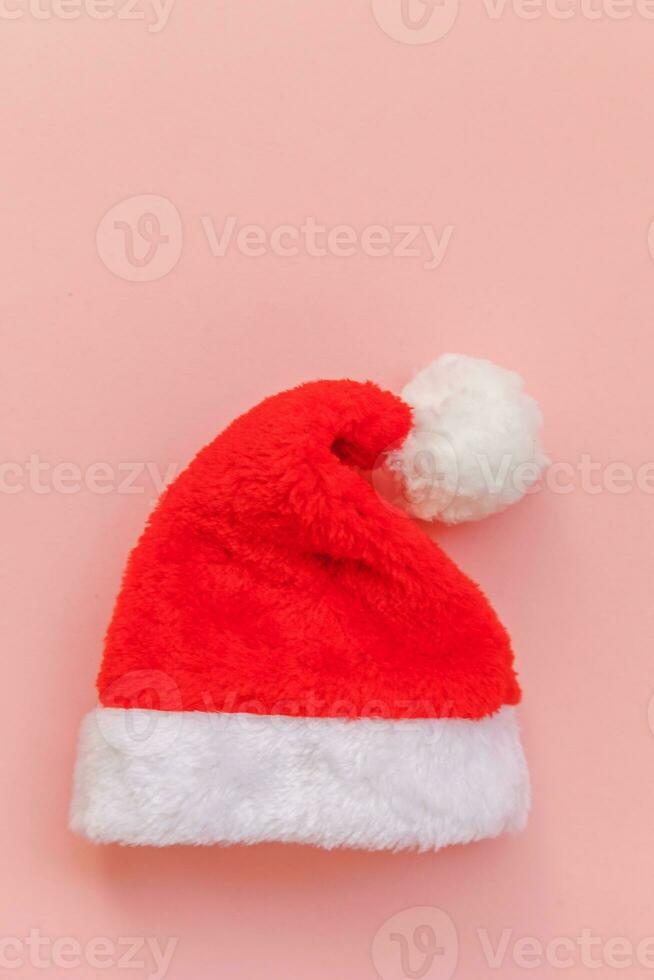 Simply minimal design Christmas Santa Claus hat isolated on pink pastel colorful trendy background photo