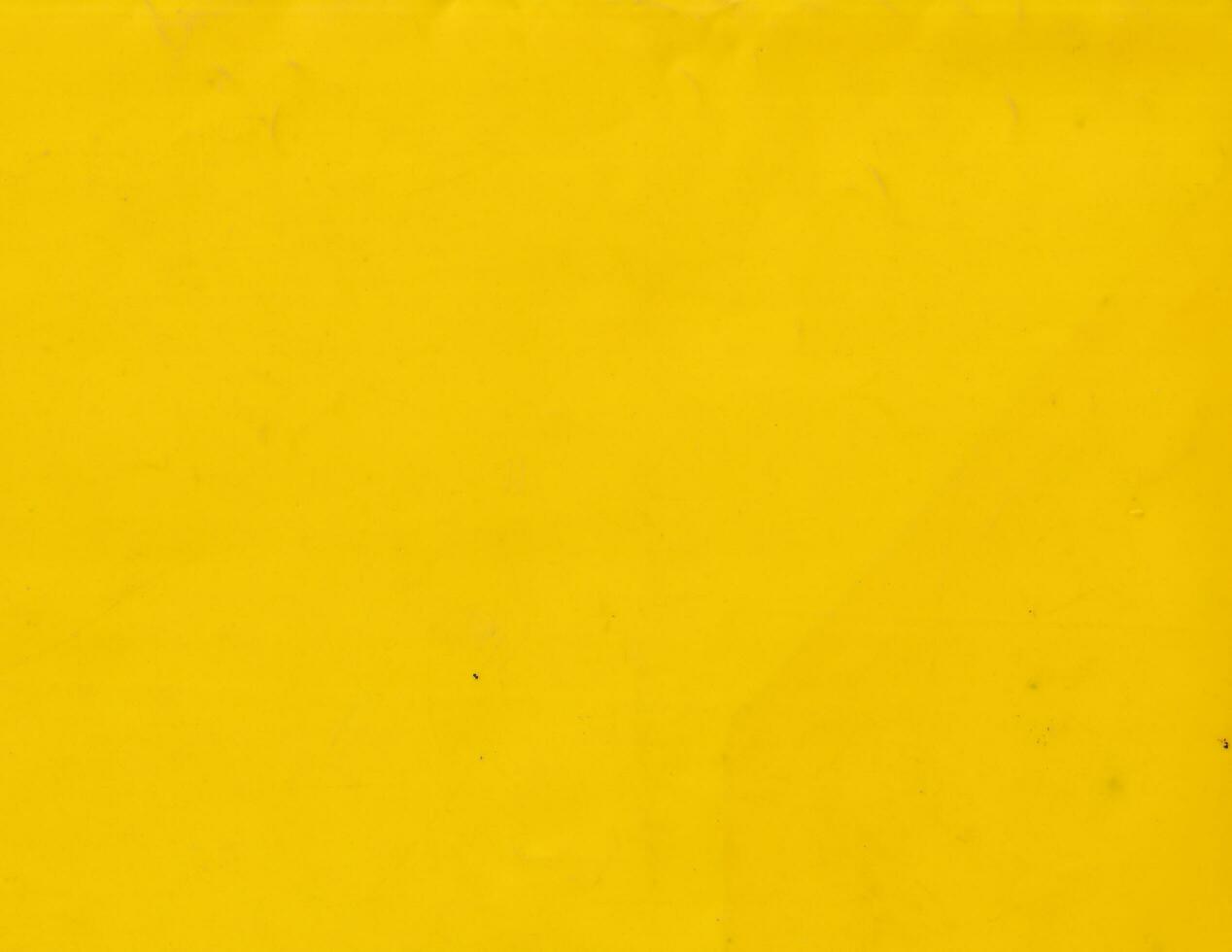 Grunge yellow plastic background template. Smooth and vibrant surface texture. photo