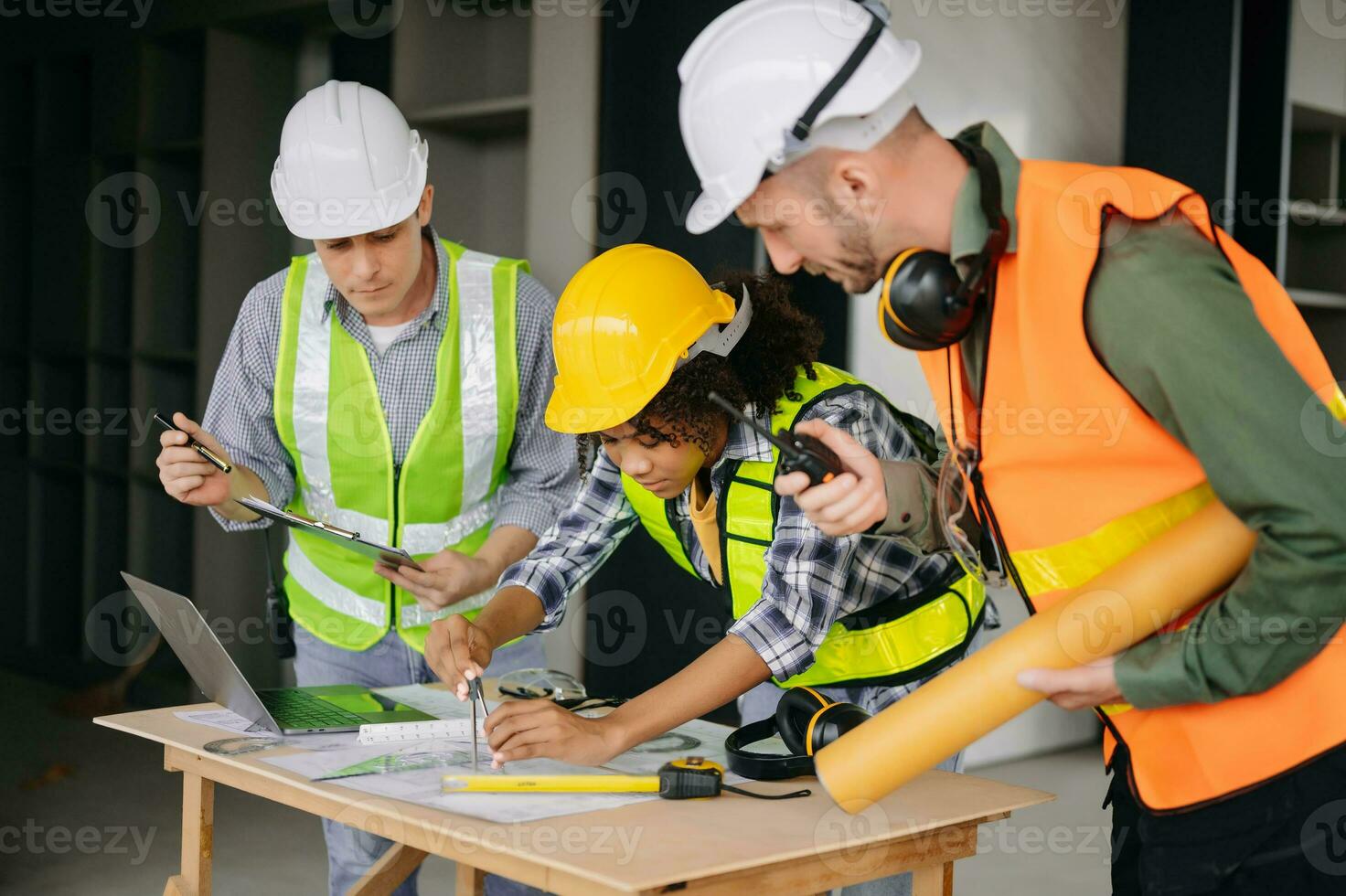 Engineers are discussing data working and laptop or tablet with architectural project at new construction site on big project. photo