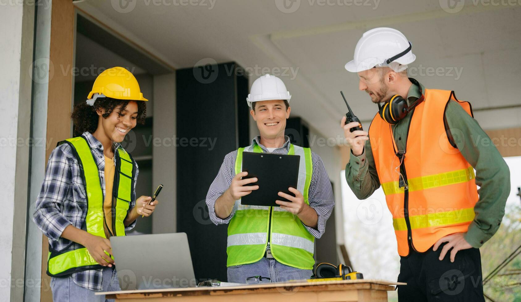 Engineers are discussing data working and laptop or tablet with architectural project at new construction site on big project. photo