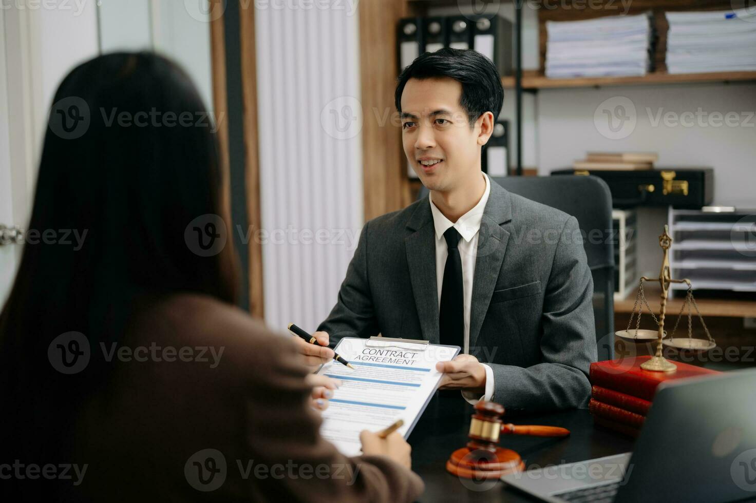 Asian Business law concept, Lawyer business lawyers are consulting lawyers for women entrepreneurs to file copyright lawsuit with laptop and tablet at office photo