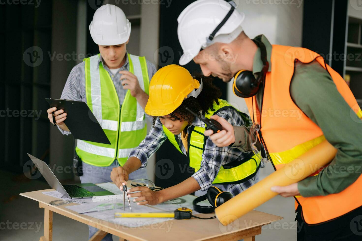 Engineers are discussing data working and laptop or tablet with architectural project at new construction site on big project. photo
