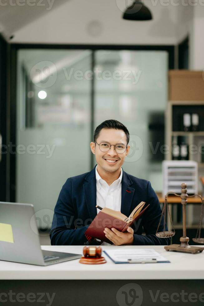 Man lawyer reading legal book with gavel on table in office. justice and law ,attorney concept. photo