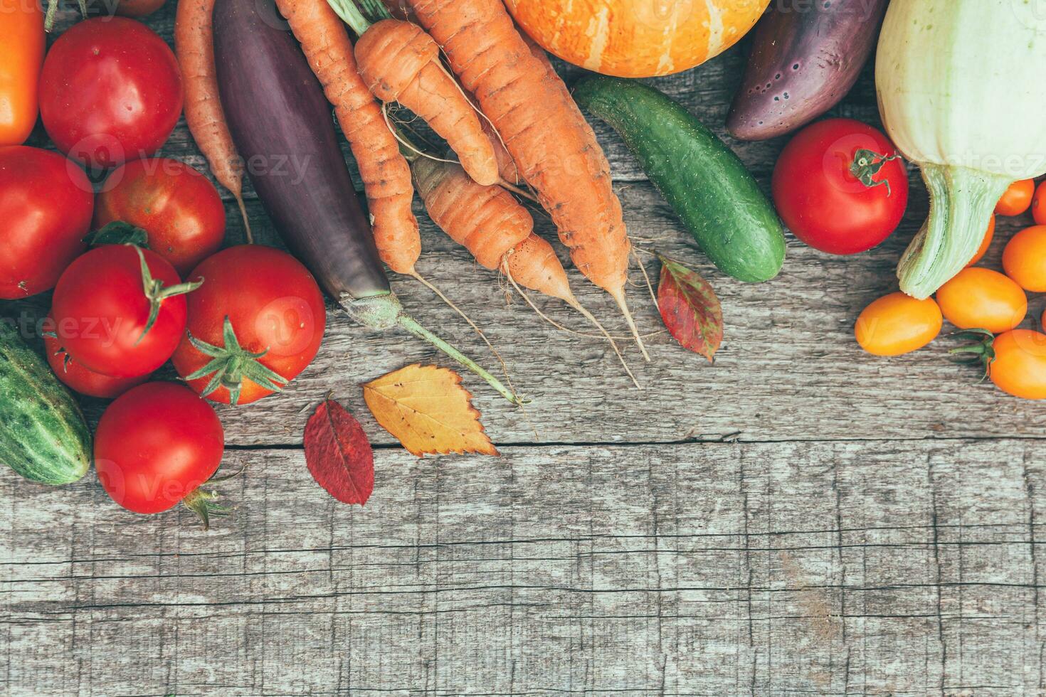 Assortment different fresh organic vegetables on country style wooden background. Healthy food vegan vegetarian dieting concept. Local garden produce clean food. Frame top view flat lay copy space. photo