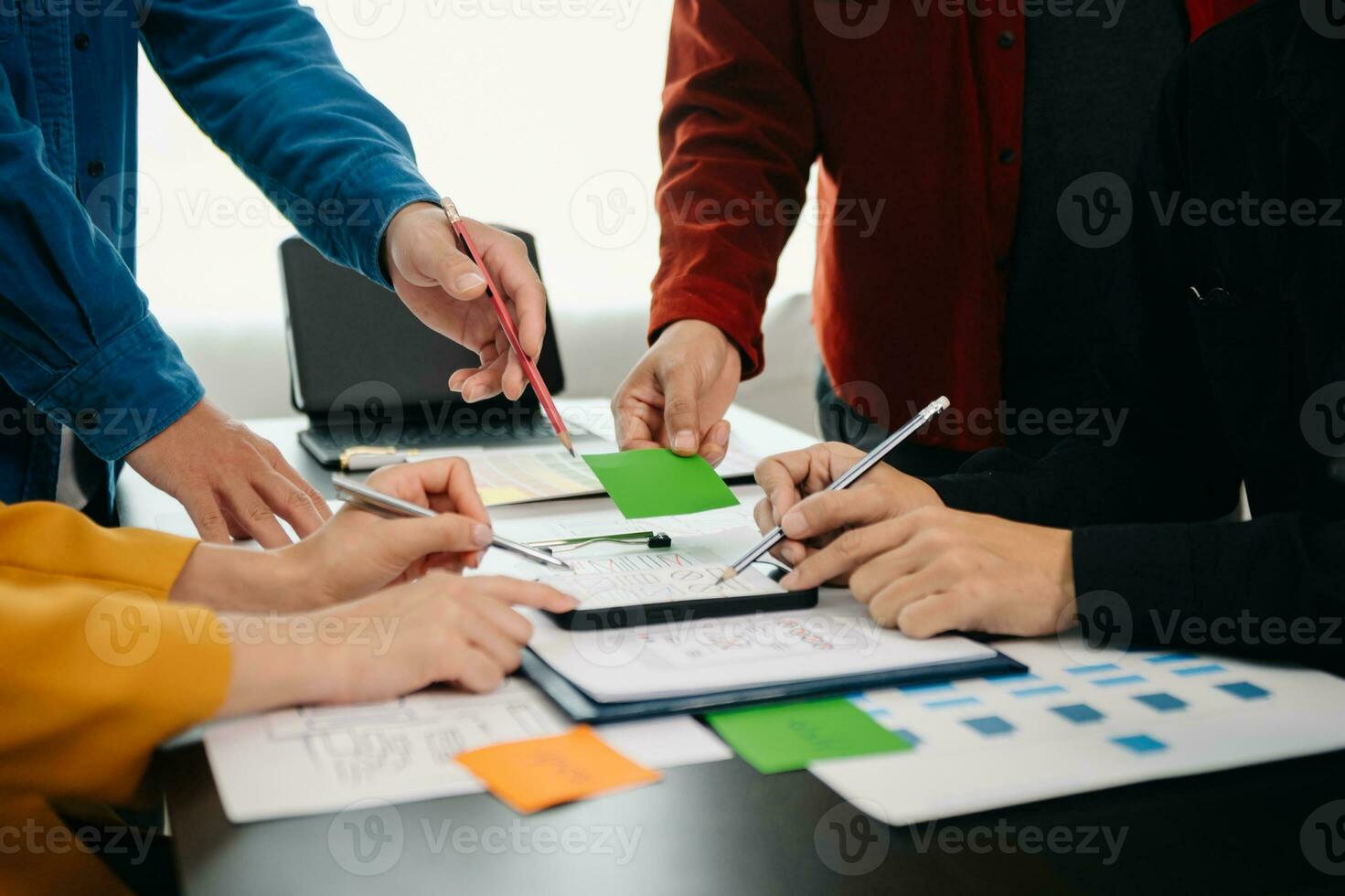 UX developer and ui designer brainstorming about mobile app interface wireframe design with customer breif and color code at office. photo