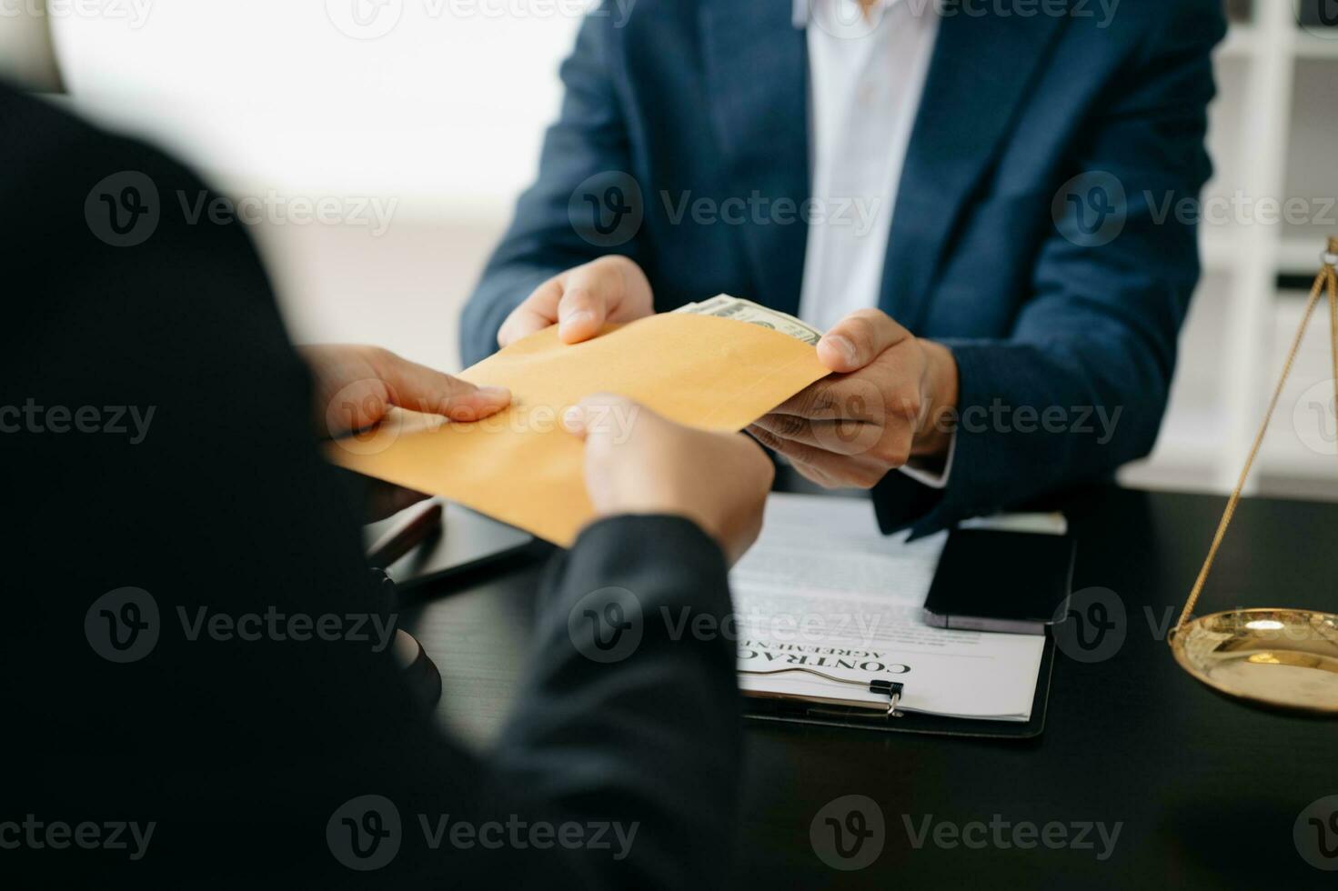 justice and law concept.passing bribe money in the envelop at lawyer office. businessman hand taking bribe money from male photo