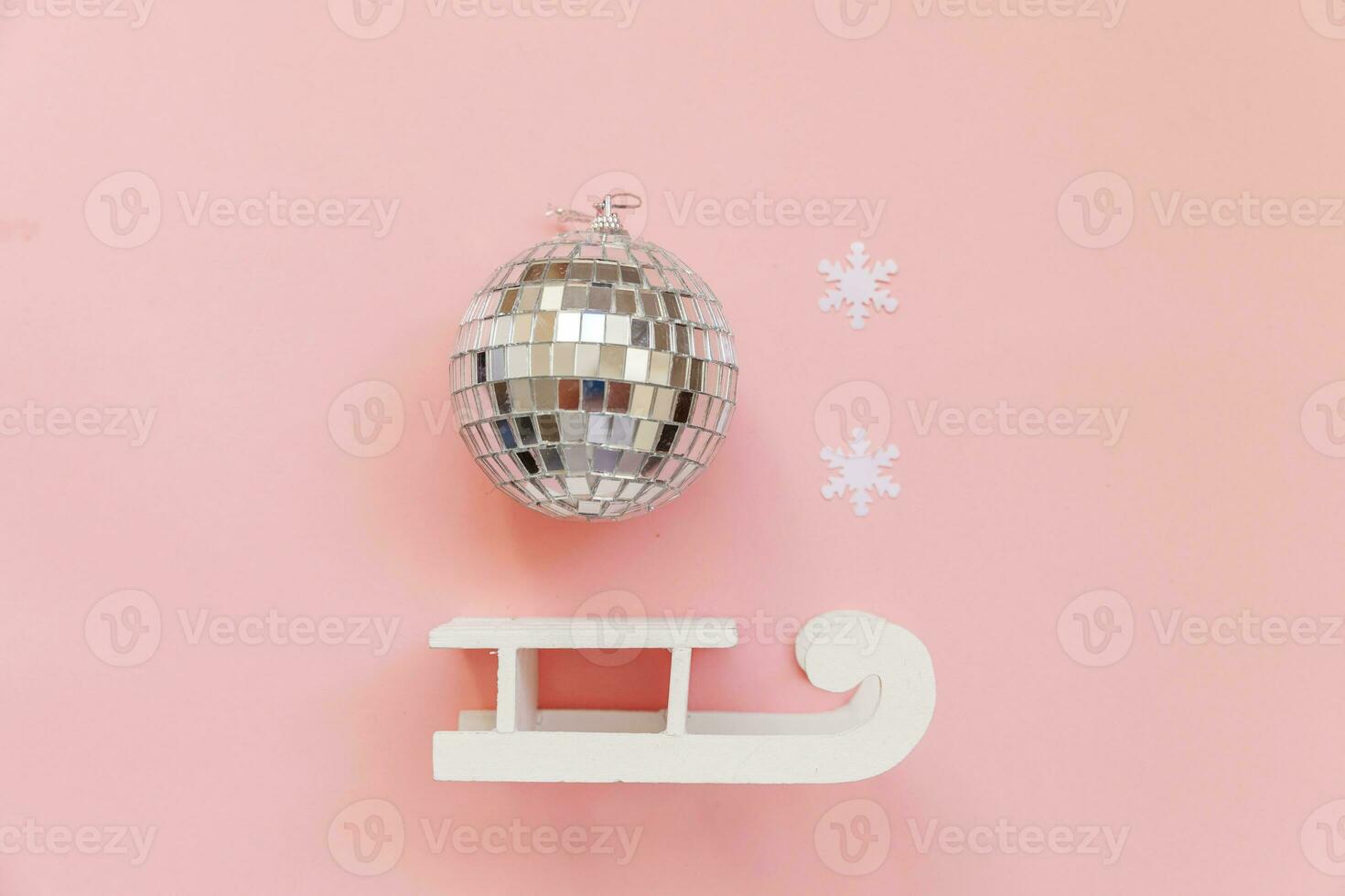 Simply minimal composition winter objects ornament ball sled isolated on pink pastel trendy background photo