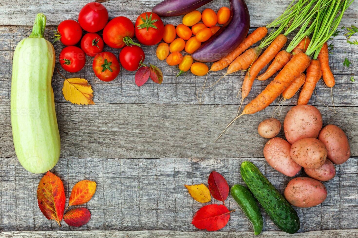 Assortment different fresh organic vegetables on country style wooden background. Healthy food vegan vegetarian dieting concept. Local garden produce clean food. Frame top view flat lay copy space. photo