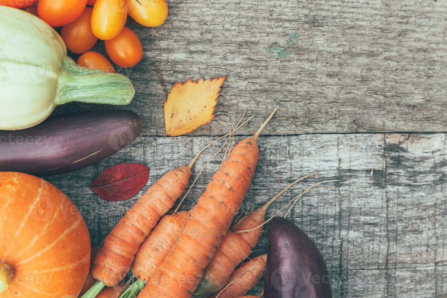 Assortment different fresh organic vegetables on country style wooden background. Healthy food vegan vegetarian dieting concept. Local garden produce clean food. Frame top view flat lay copy space. photo