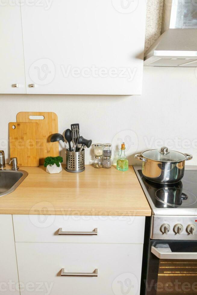 Scandinavian classic minimalistic kitchen with white and wooden details. Modern white kitchen clean contemporary style interior design. photo