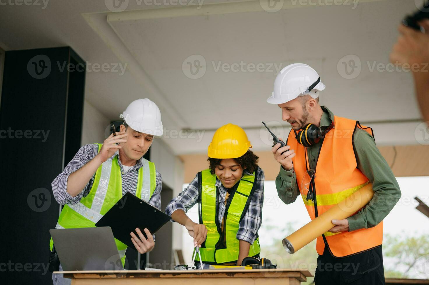 Engineers are discussing data working and laptop or tablet with architectural project at new construction site on big project. photo