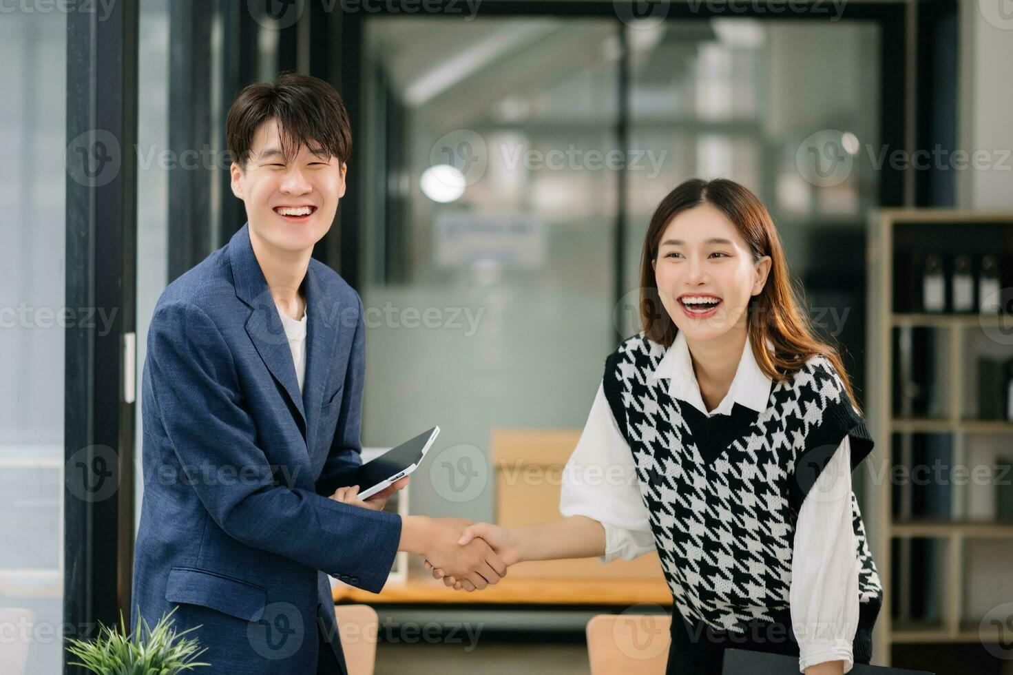 Two confident business man shaking hands during a meeting in the office, success, dealing, greeting and partner in sun light photo