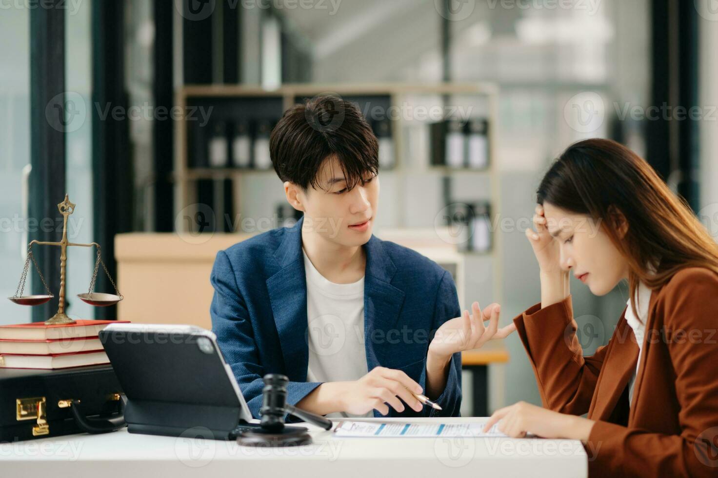 Business people compassionately holding hands and discussing contract papers with laptop and tabletat in office room. photo