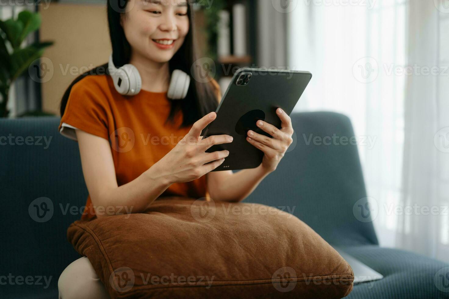 Woman using smart phone for mobile payments online shopping, omni channel, sitting on table, virtual icons graphics interface screen photo