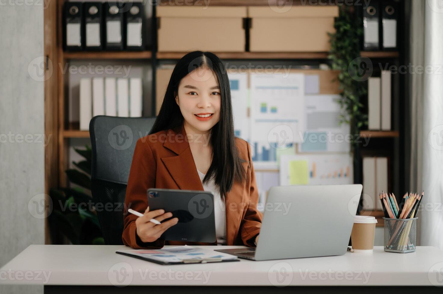 Business woman using tablet and laptop for doing math finance on an office desk, tax, report, accounting, statistics, and analytical research concept photo