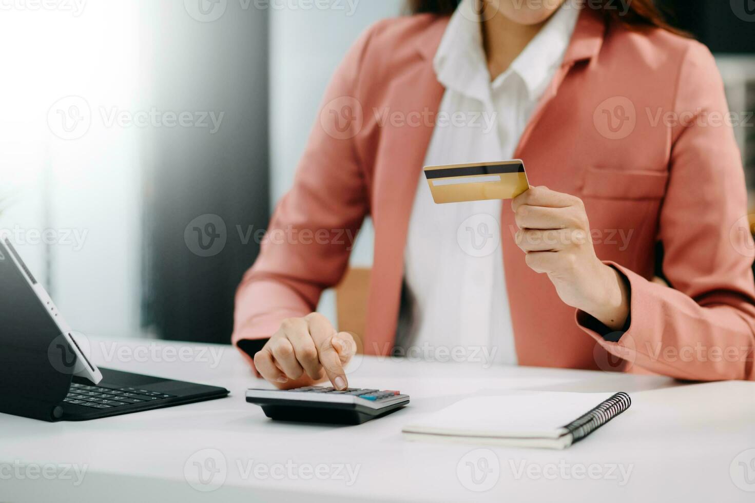 Woman using smart phone for mobile payments online shopping, omni channel, sitting on table, virtual icons graphics interface screen photo