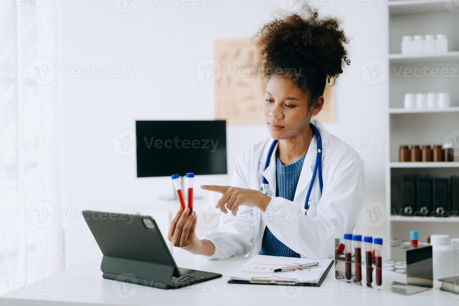 African doctor or consultant sitting at a desk writing sick note, surgery planning and prescription.and clinical report test results in office photo