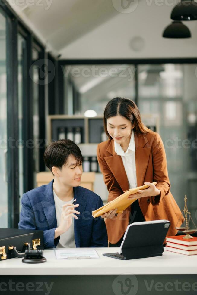 Asian business team and lawyers discussing contract papers sitting at the table. Concepts of law, advice, legal services. at office photo