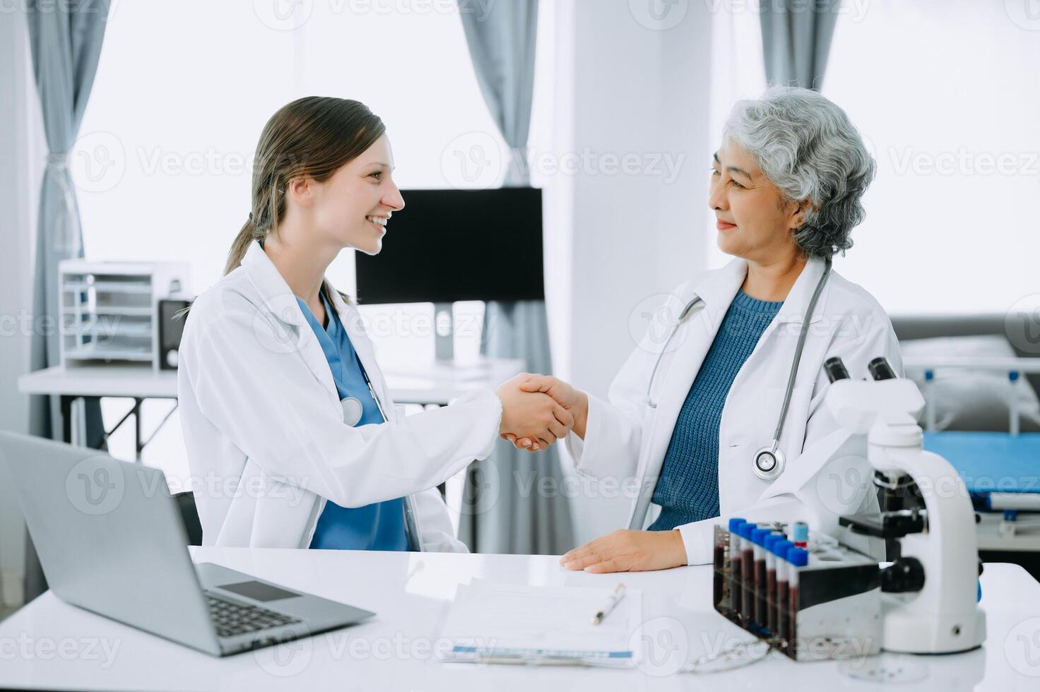 Doctor handshake and partnership in healthcare, medicine or trust for collaboration, unity or support.Team of medical experts shaking hands in teamwork for or success in clinic or hospital photo