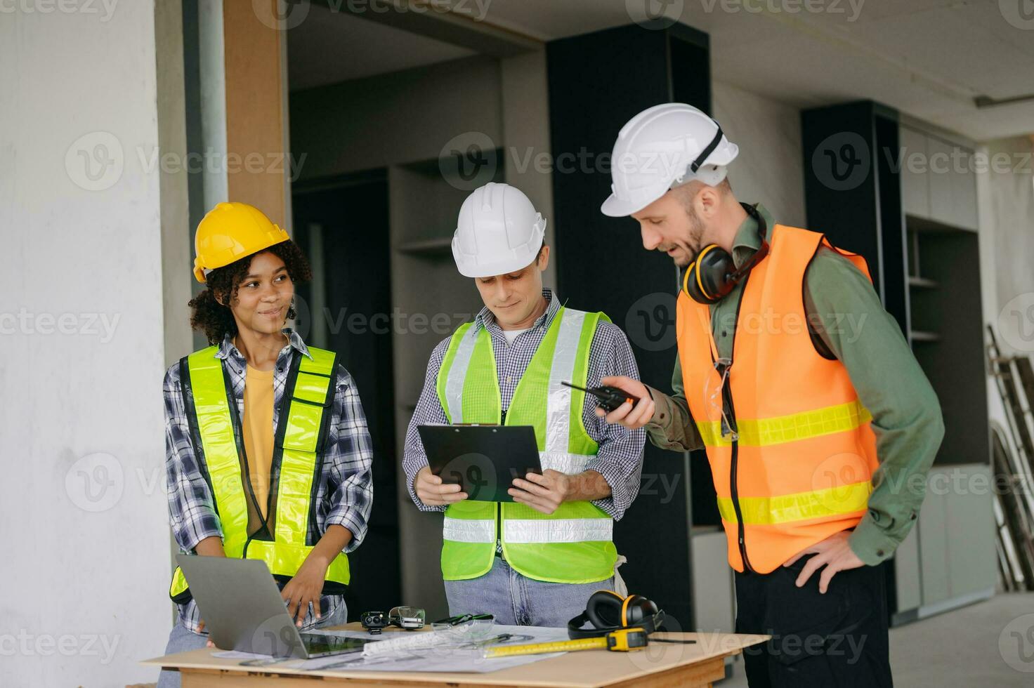 Engineers are discussing data working and laptop or tablet with architectural project at new construction site on big project. photo