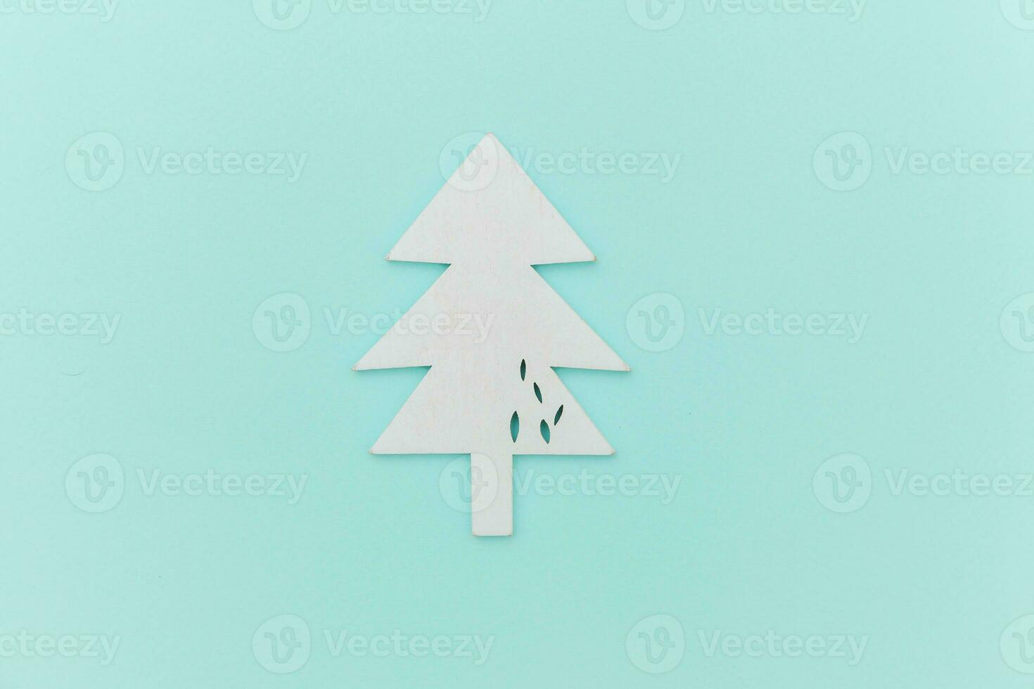 Simply minimal composition winter objects ornament fir tree isolated on blue pastel trendy background photo