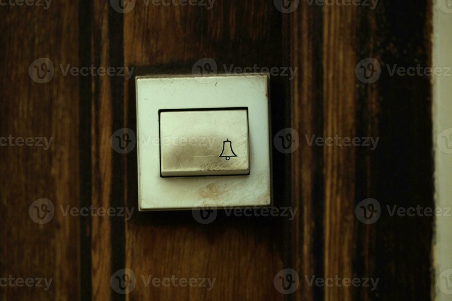 Close up on a filthy old electric doorbell fitting photo