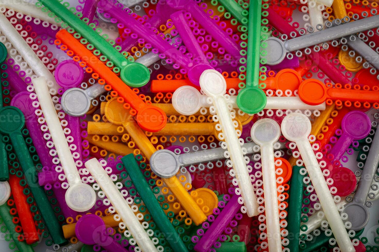 group of colorful O-rings for use with brackets for orthodontics dental. photo