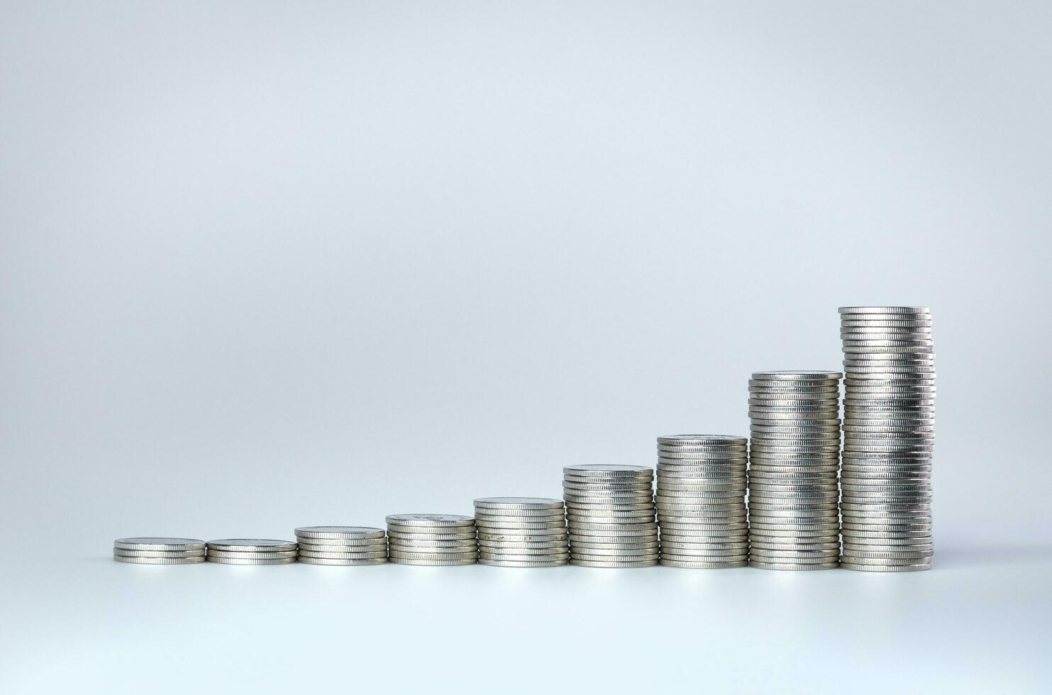 Stack of silver thai coins like income graph. coins arranged as a graph. photo