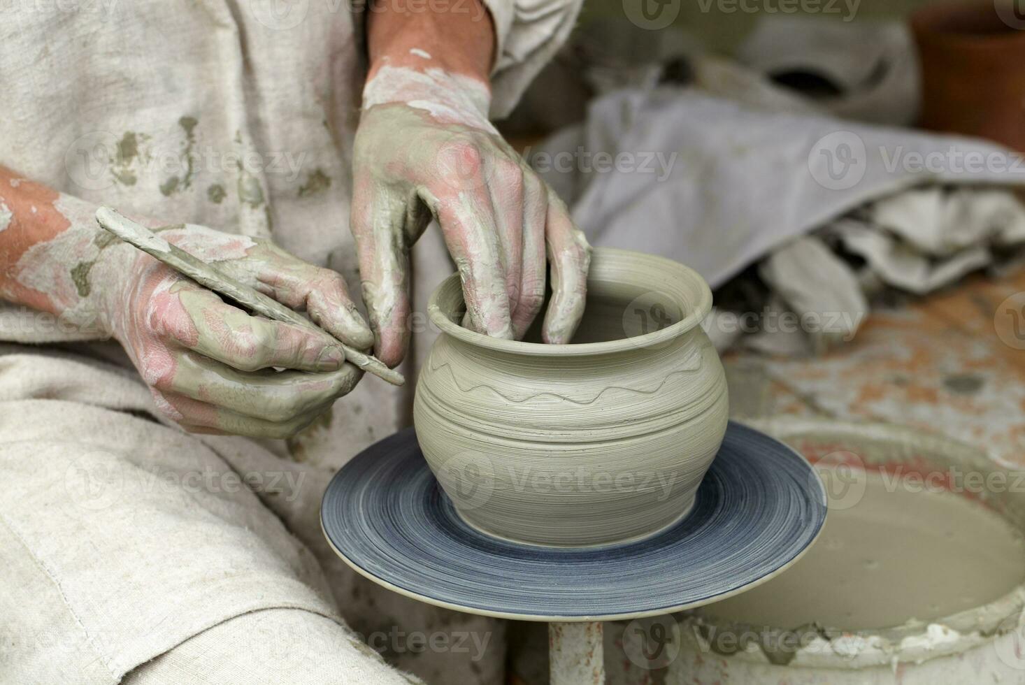 The potter's hands shape the clay pottery photo