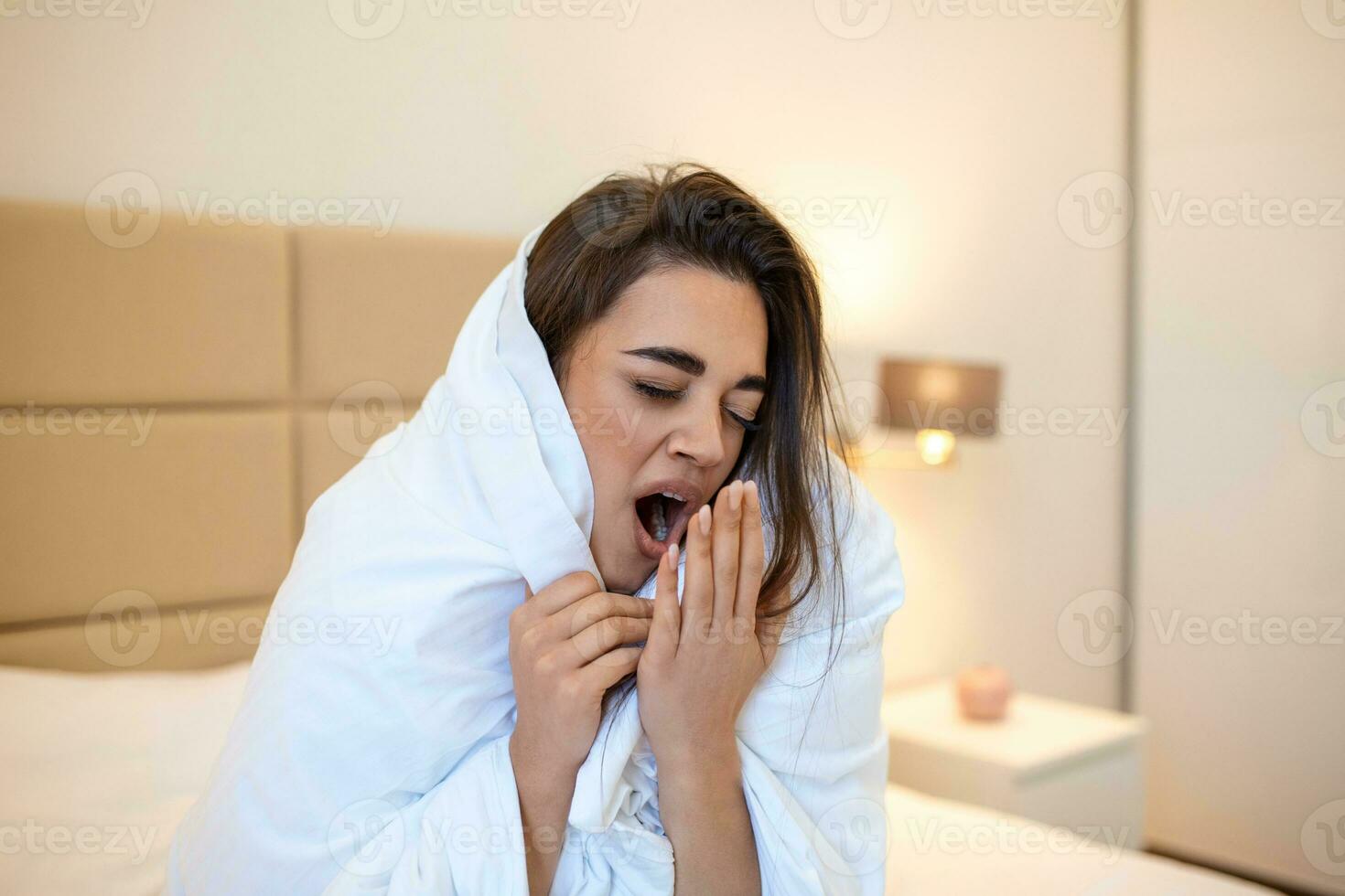 Woman wrapped in a blanket after wake up Yawn , entering a day happy and relaxed after good night sleep. Sweet dreams, good morning, new day, weekend, holidays concept photo