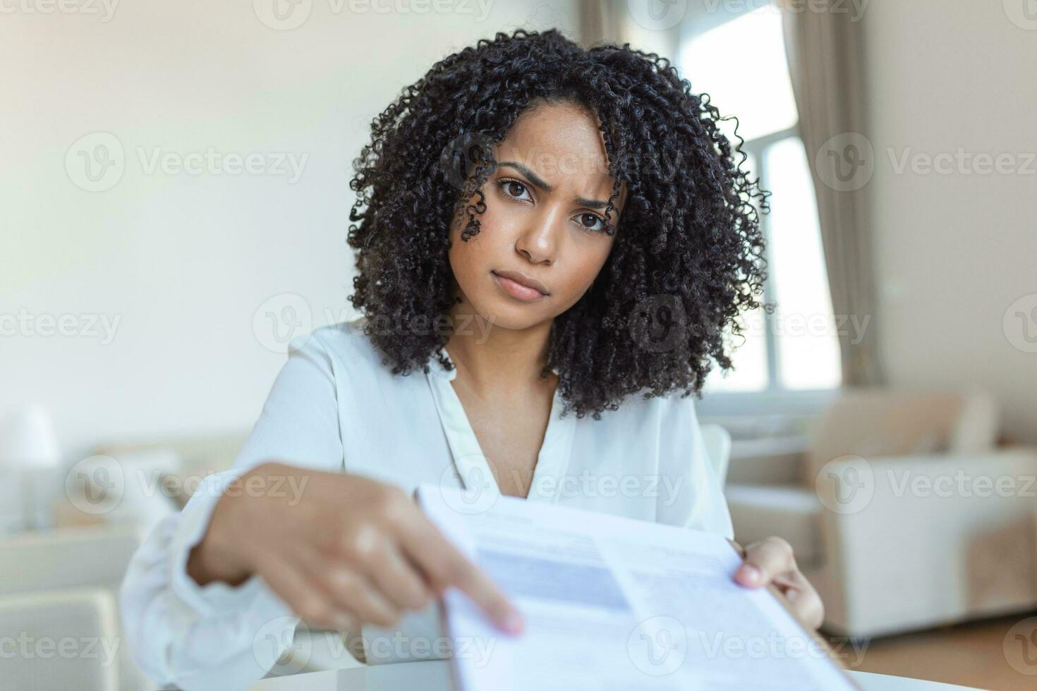 Cropped view of female lawyer giving document and pen, while sitting at workplace with themis figurine on blurred background photo