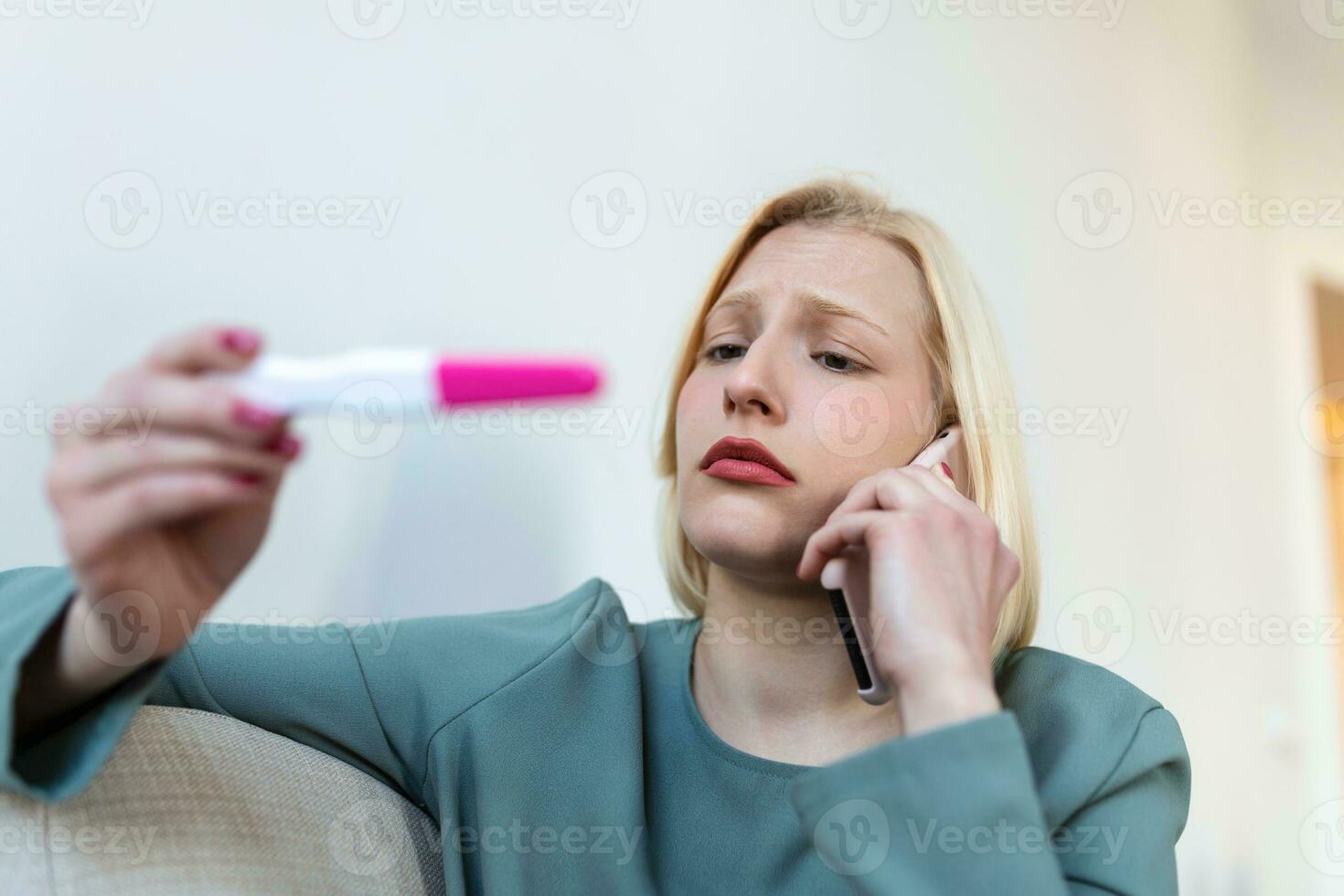 Shocked woman looking at control line on pregnancy test. Single sad woman complaining holding a pregnancy test . Depressed woman holding negative pregnancy test. photo