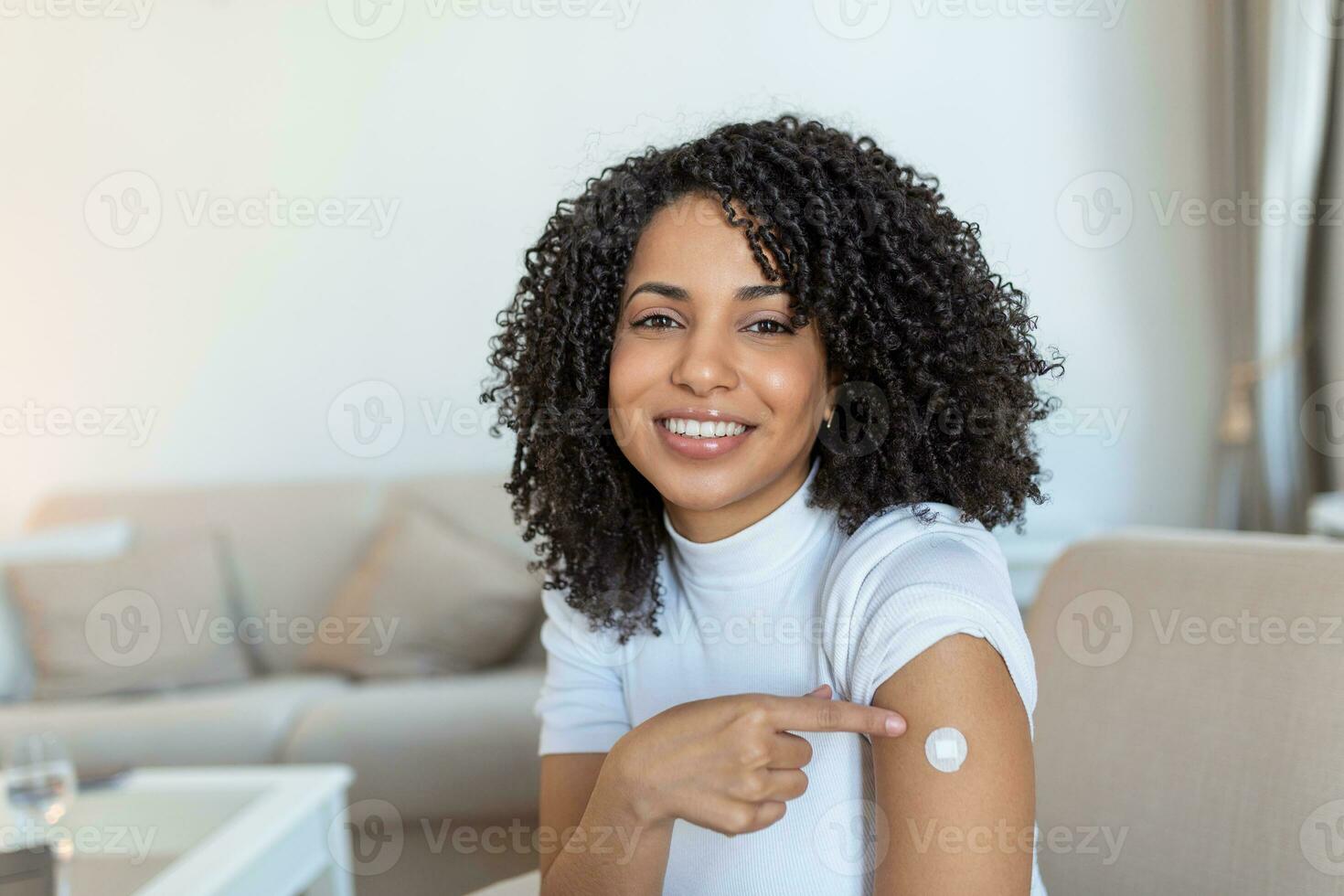 Covid-19 Vaccination. Portrait Of Happy Vaccinated African woman Showing Her Arm After Coronavirus Antiviral Vaccine Shot . Covid Immunization Campaign Concept. photo