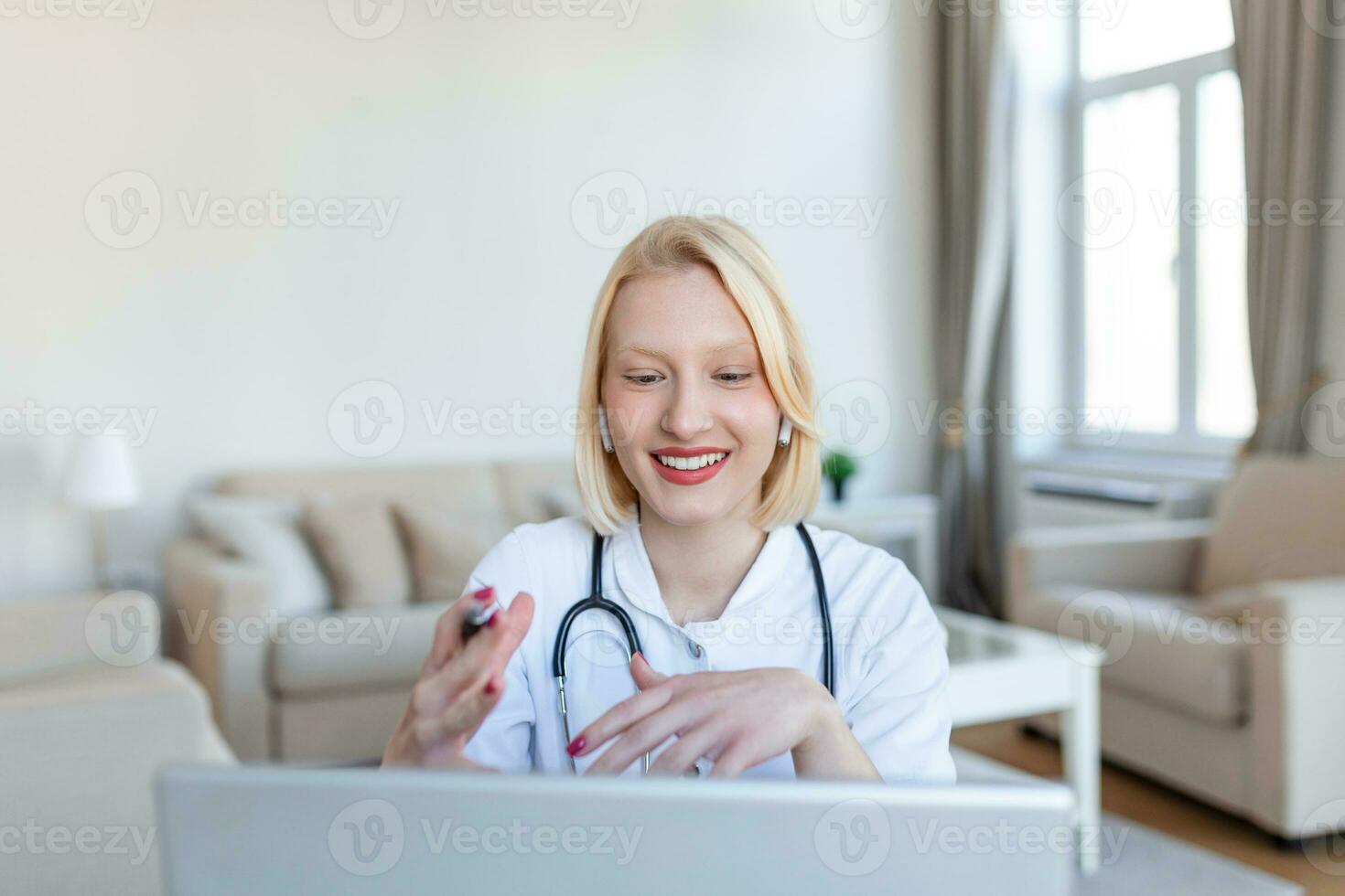 Attractive female doctor talking while explaining medical treatment to patient through a video call with laptop in the consultation. photo