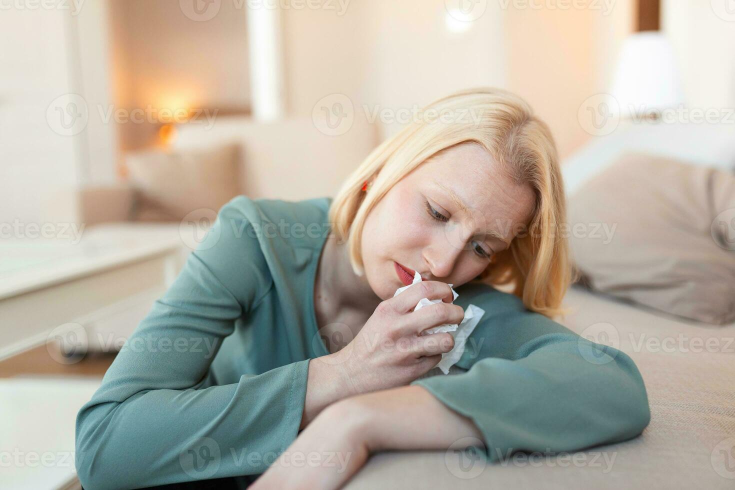 Unhappy young woman covering face with hands, crying alone close up, depressed girl sitting on couch at home, health problem or thinking about bad relationships, break up with boyfriend, divorce photo