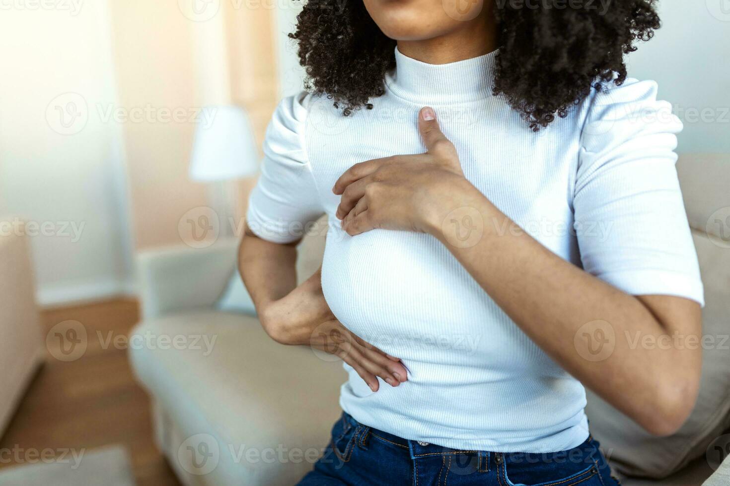 African American Woman hand checking lumps on her breast for signs of breast cancer. woman is suffering from pain in the breast. BSE or Breast Self-Exam. Guidelines to check for breast cancer. photo