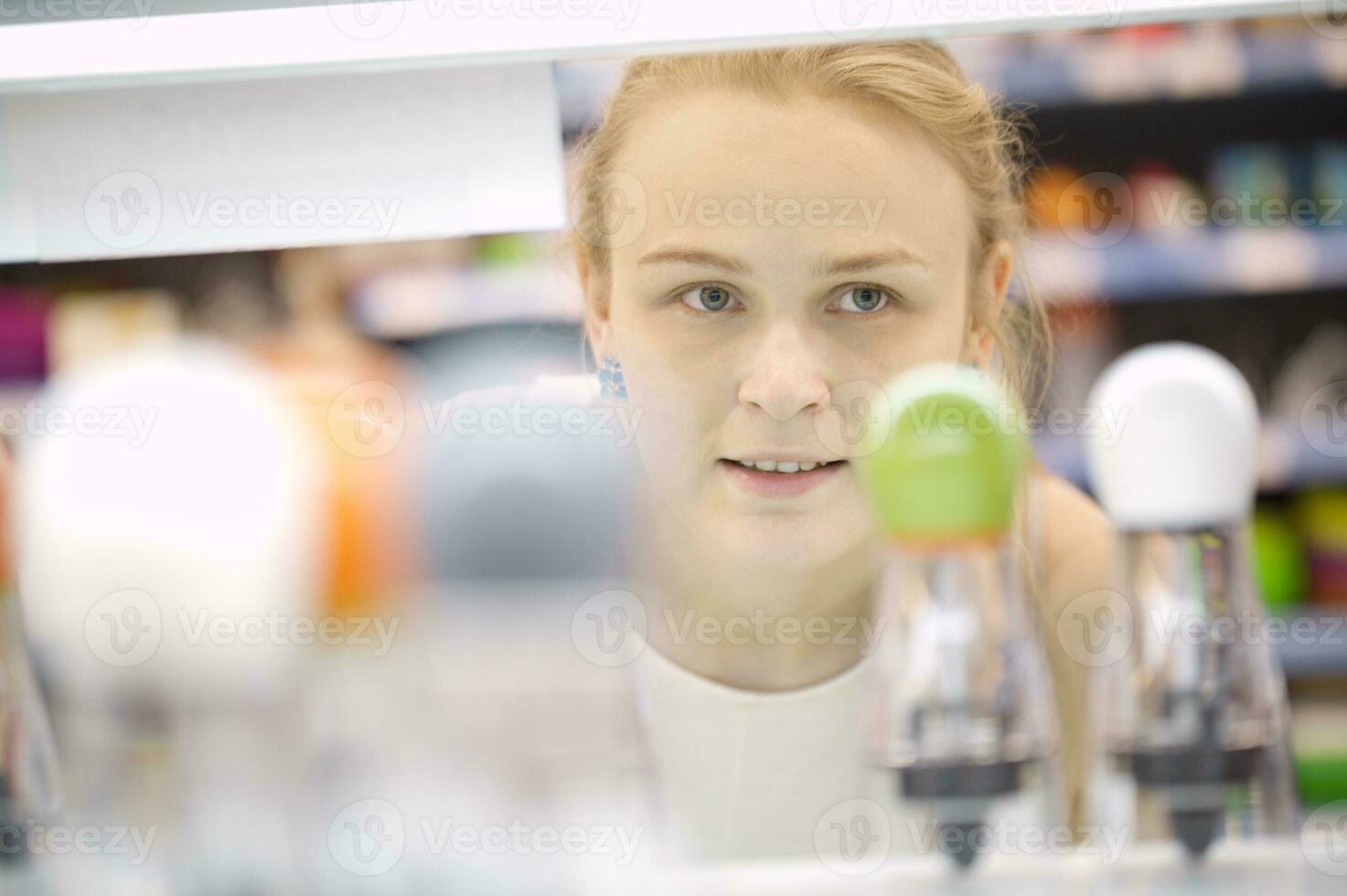 Young woman analyzing products in a store photo