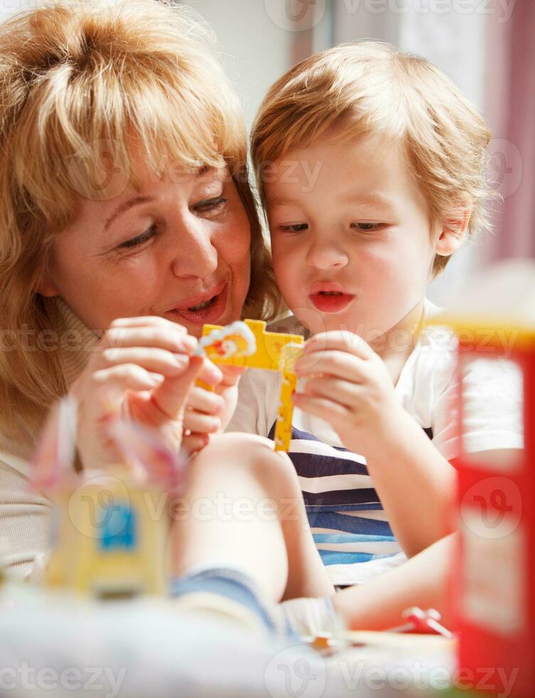 Grandmother playing with her grandson photo