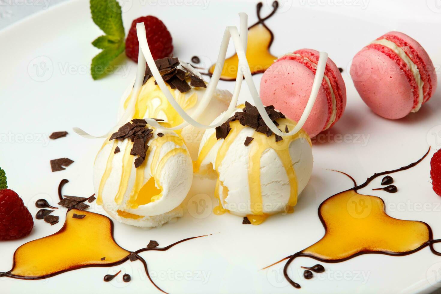 Pink macaroons with vanilla ice cream and honey photo