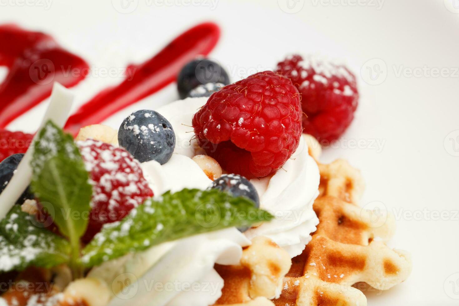 Waffle and cream topped with fresh berries photo