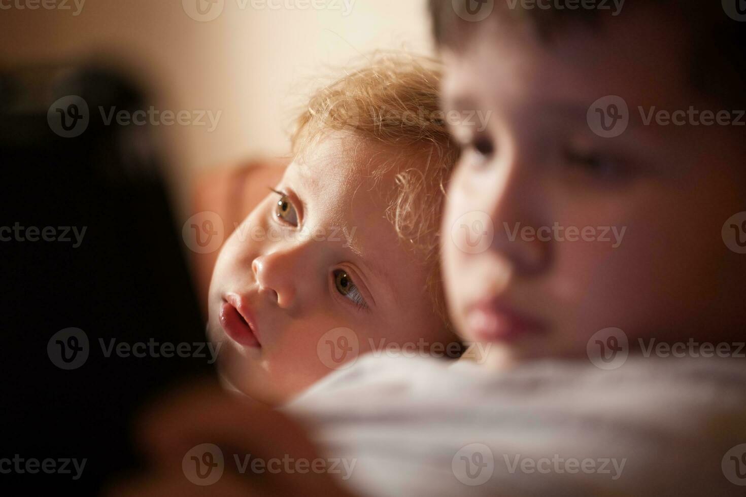 Cute young child relaxing with his brother photo