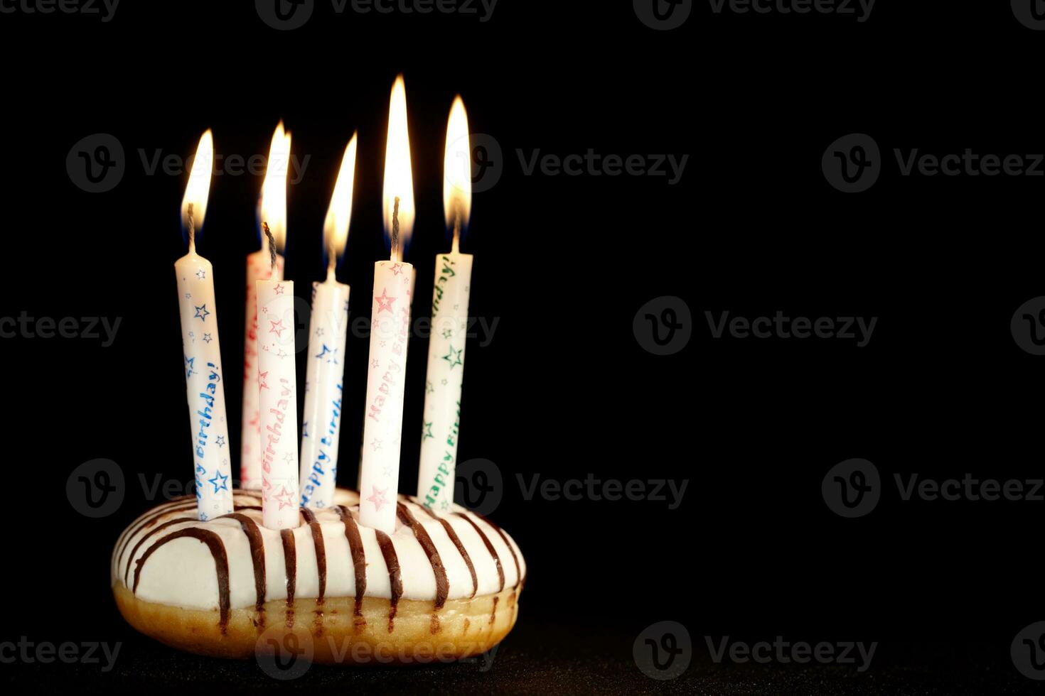 Many candles on doughnut. photo