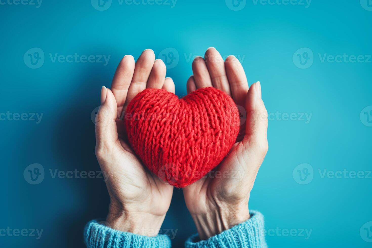 elderly female hands holding a knitted red heart made of threads.ai generative photo