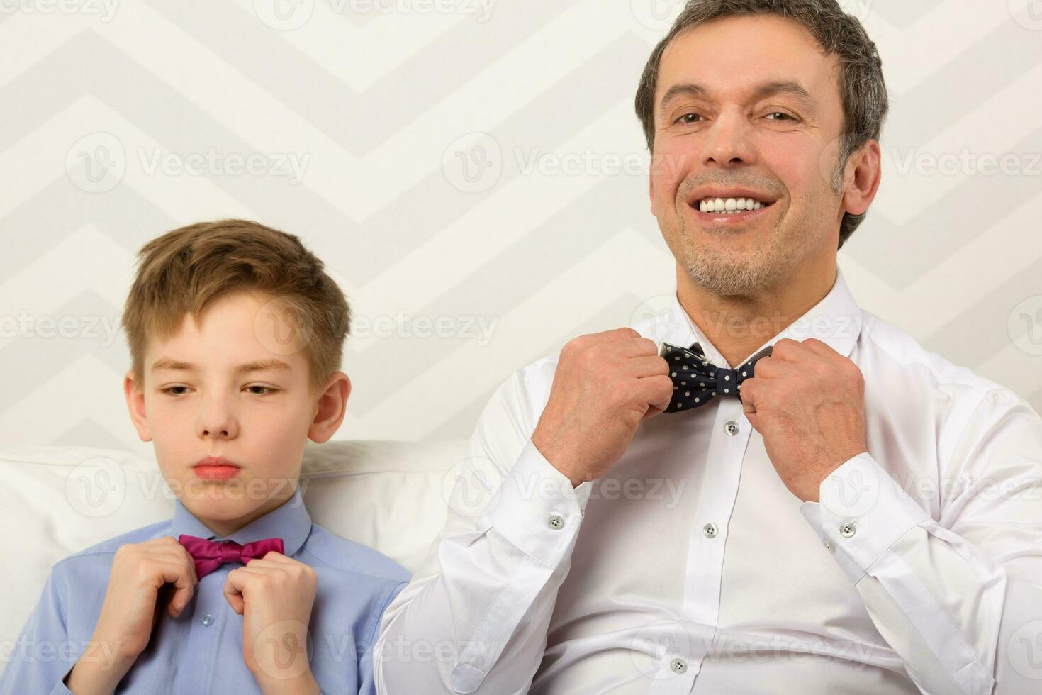 Father and son adjusting bowties photo