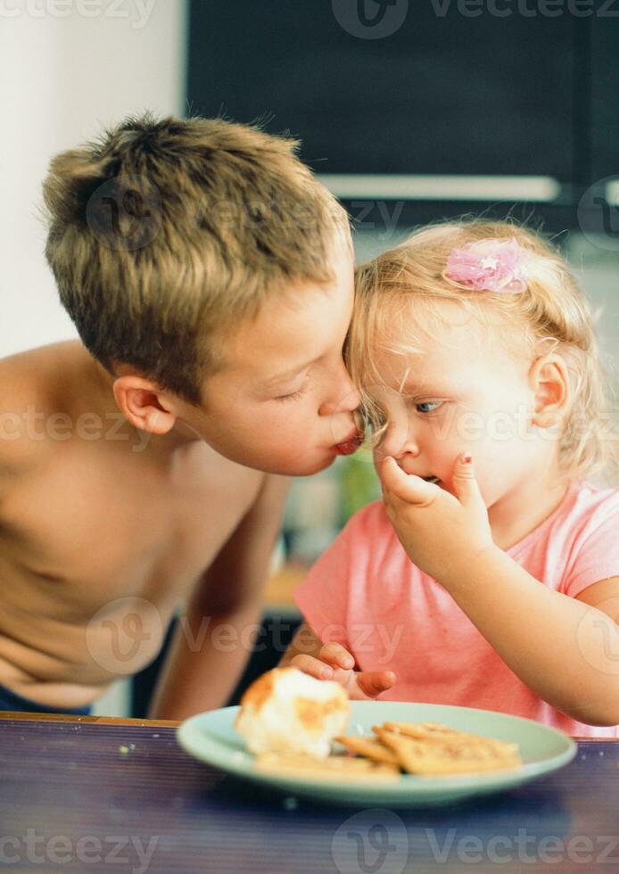 Brothers kiss for beloved little sister photo